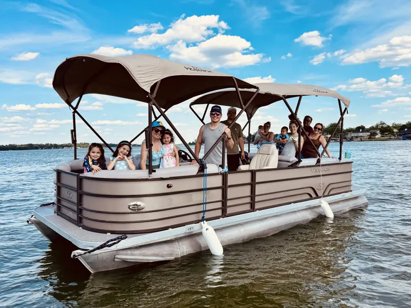 Veranda V22RC pontoon on Lake Conroe full of smiling family and friends standing under the shaded top