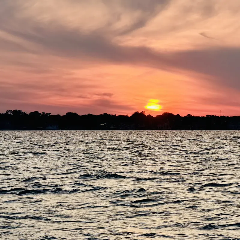 Orange and pink sunset over Lake Conroe seen from the Veranda V22RC
