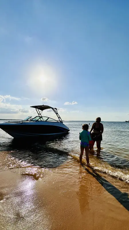Yamaha AR190 at the Lake Conroe shore with a woman and a child standing in the shallow water beside it