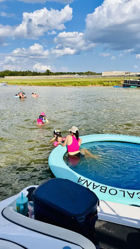 Kids and a woman playing in a floating island in the shallow water of Lake Conroe, an add-on available with the Yamaha AR190