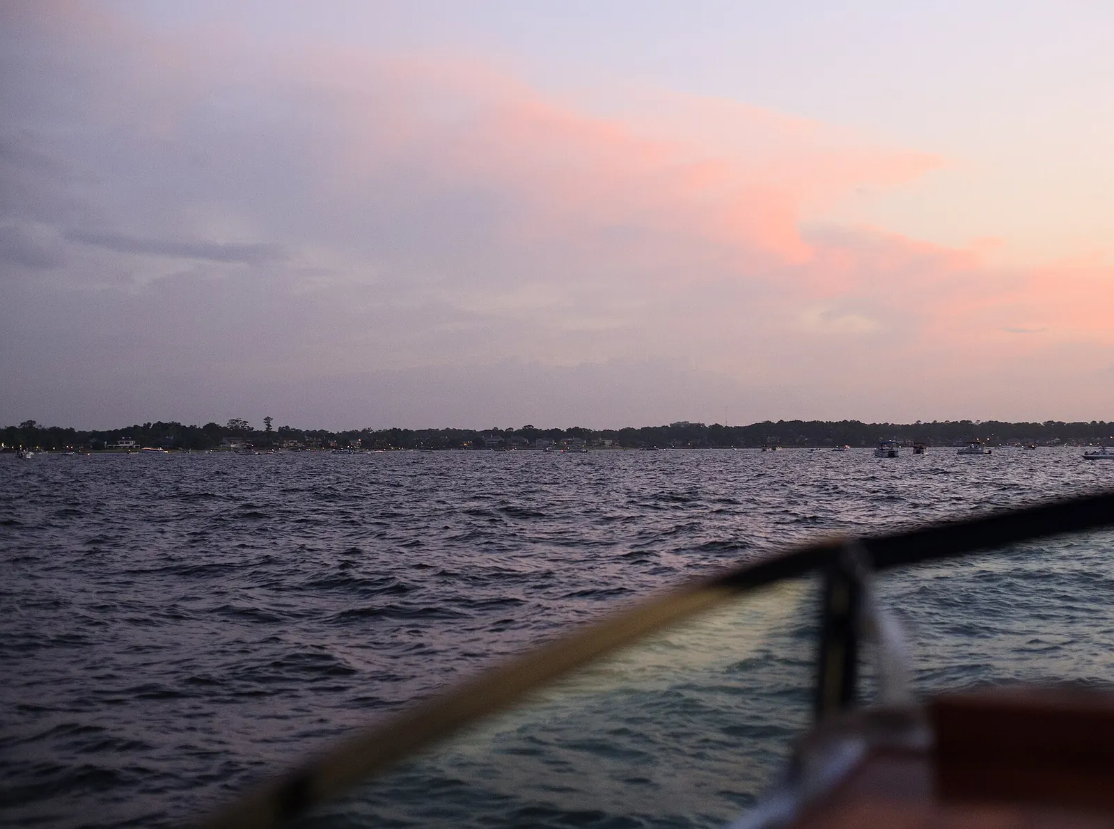 Sunset sky over Lake Conroe seen from the bow of a boat